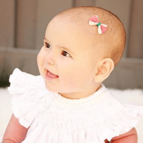 Girlie Glue is perfect for sticking bows to babies. It is made with Agave nectar and other all-natural ingredients. It is safe for skin and hair and washes away easily with water.