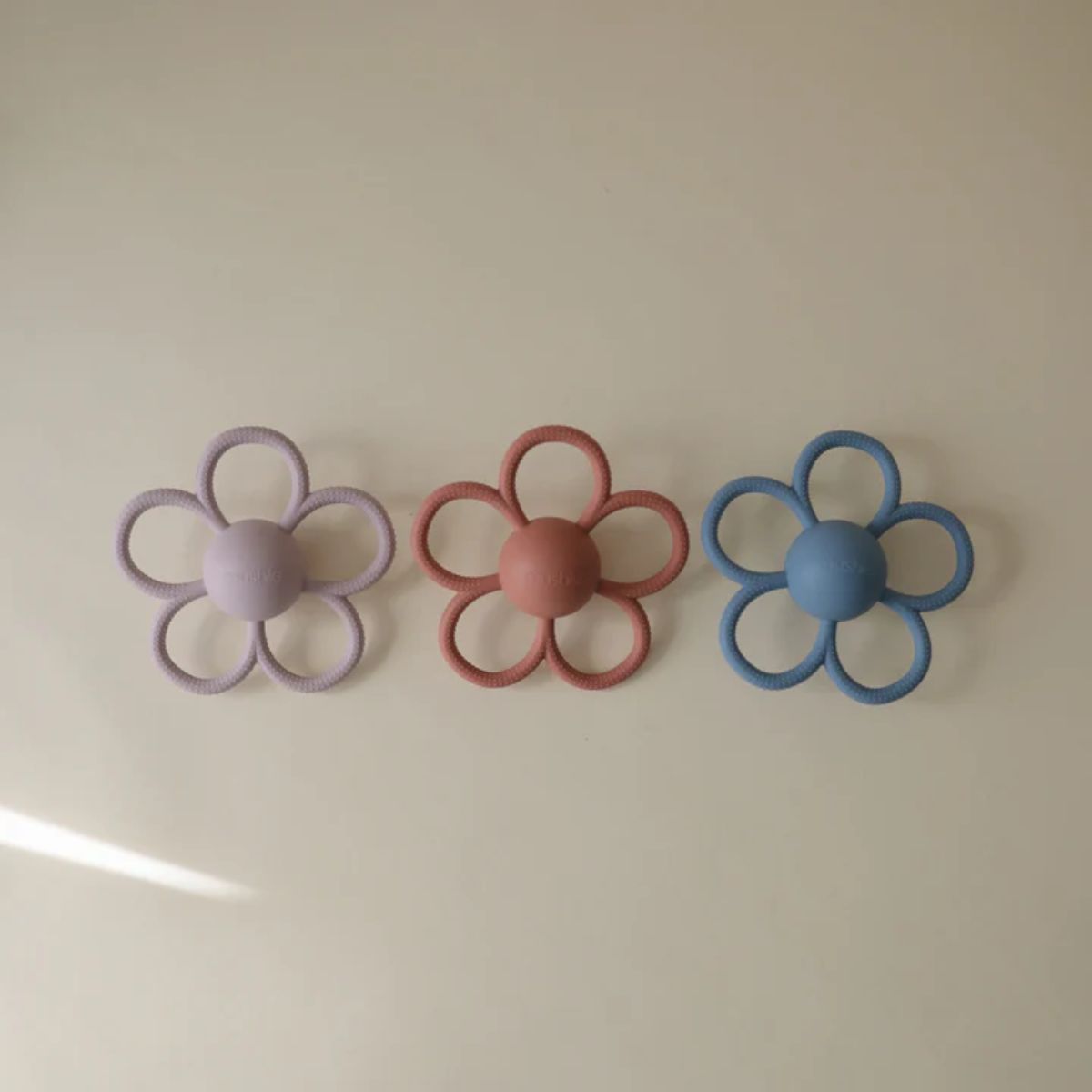 Mushie Silicone Daisy Rattle Teether - Dusty Rose on Luna Baby Store Miami